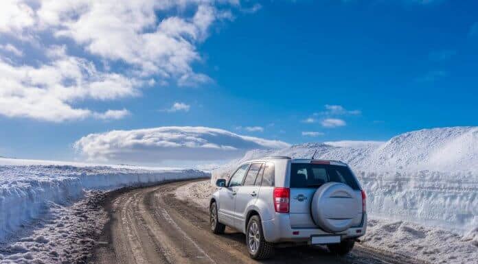 Car driving on icy, ashy, sandy roads in Iceland